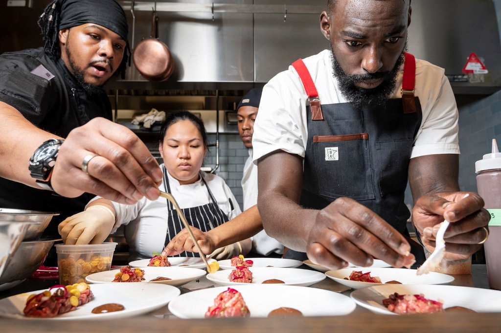 From left, Mr. Mance, Aisah Siraj, Tyrik Smith and Mr. Adjepong work to plate the steak tartare.CreditKarsten Moran for The New York Times