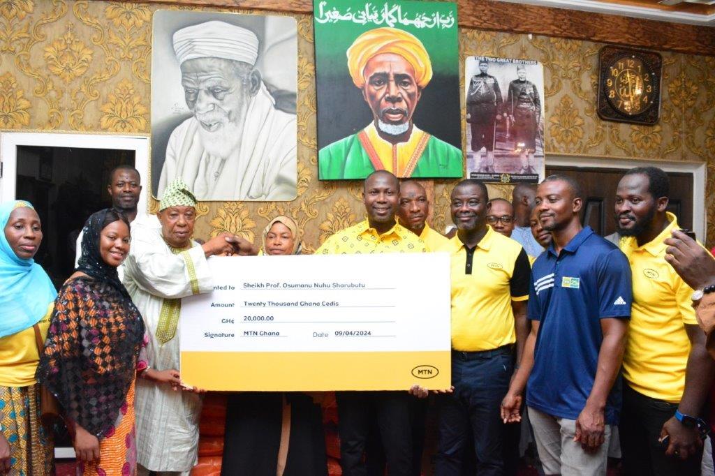 Salihu Abu of MTN Senior Manager for Customer Relations and Credit Management presenting the items to Alhaj Latif PRO of the National Chief Imam